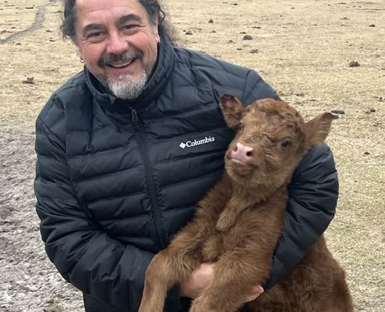 Tim holding a brown calf